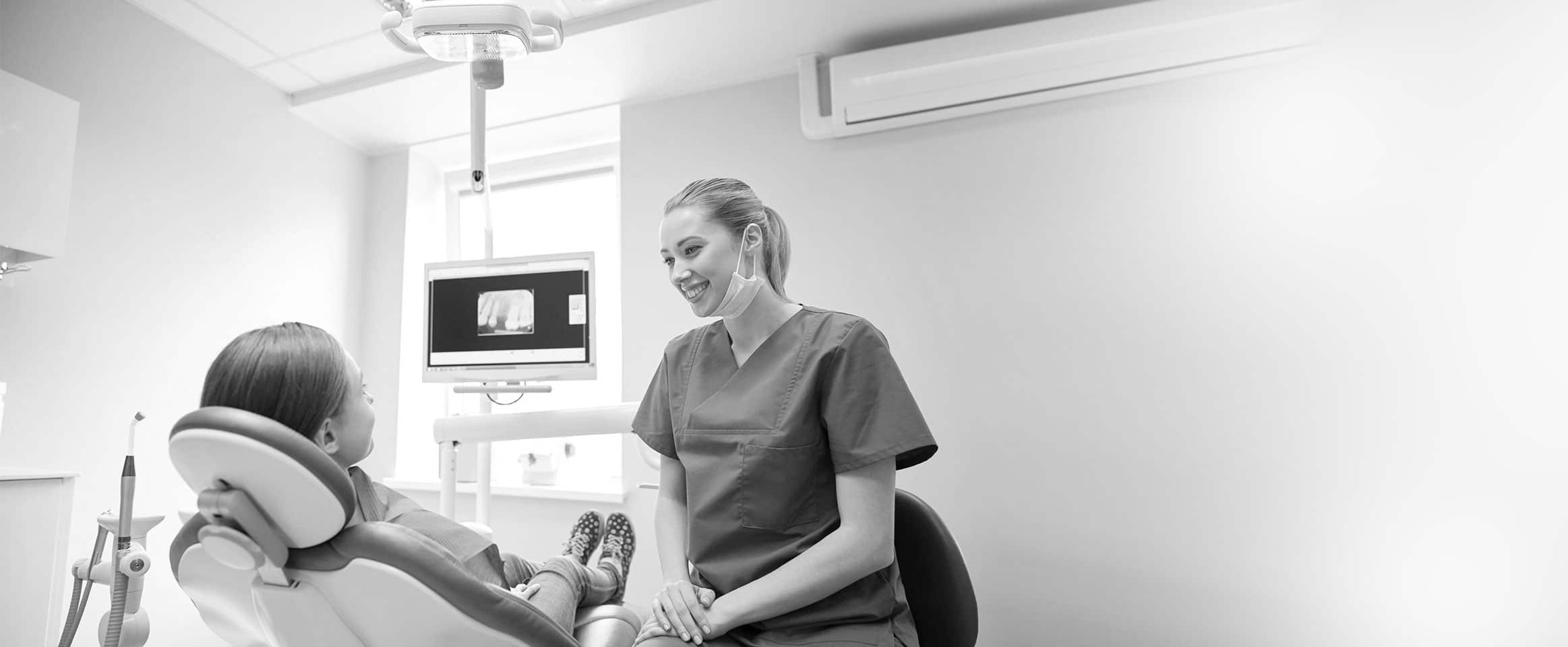 Dentist smiling confidently wearing their uniforms in a clinic.